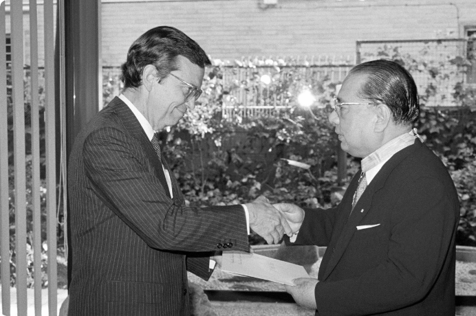 画像:授章の勲記が贈呈されブエノ大使と握手を交わす